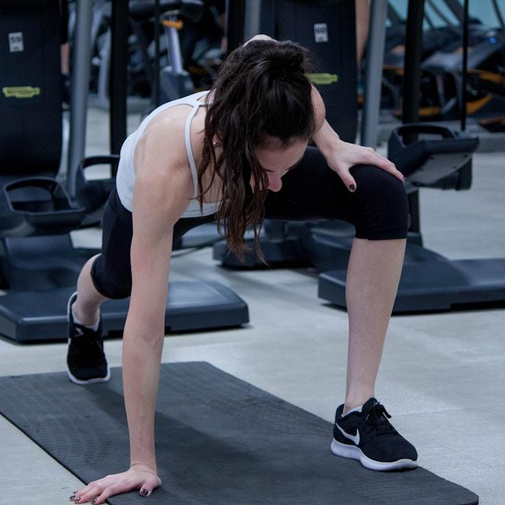 Women in a fitness class doing stretching and mobility exercises